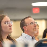 Group of people listening to a speaker